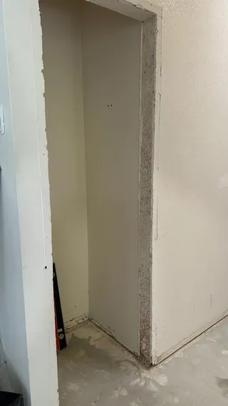 Bathroom doorway and partition wall at a board preparation stage.